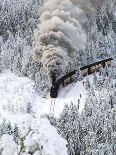 a train is coming down the tracks in the snow