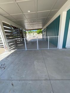 an empty parking lot next to a building with a gated in area on one side