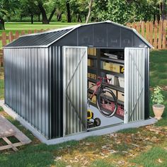 a shed with a bicycle in the door