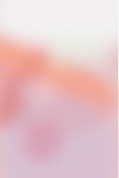 a blurry image of an orange and pink background