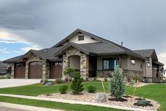 a large house with lots of landscaping in the front yard