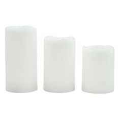 three white candles sitting next to each other