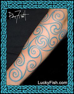 a blue and white tattoo design on someone's arm with swirls in the middle