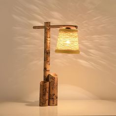 a lamp made out of bamboo sticks with a yellow shade on the top and bottom