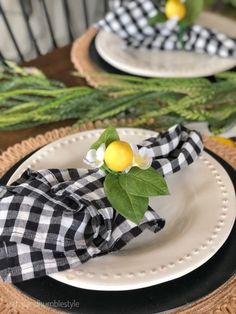 two plates with napkins and lemons on them