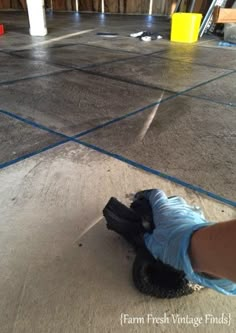 a person wearing blue gloves is standing on the floor