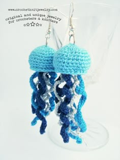 a pair of blue and white crocheted jellyfish earrings