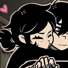 two people hugging each other in front of a wall with hearts and arrows on it