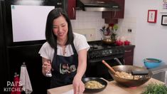 a woman standing in a kitchen preparing food