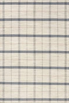 a white and grey plaid rug with black stripes