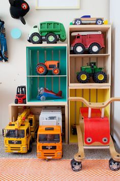 toy trucks and tractors are on shelves in a playroom