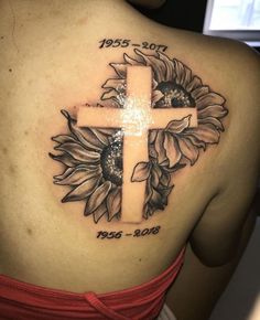 a woman with a cross and sunflower tattoo on her back