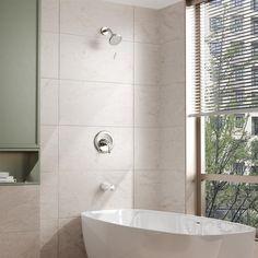 a white bath tub sitting next to a window