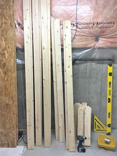 some wooden planks are laying on the floor in a room with construction materials around them