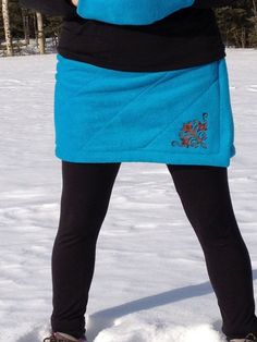 "The Quilted Bum Daisy will keep you warm while being active outside.  Whether you are hiking, walking, jogging, cross country skiing, or dog mushing, this is the skirt for you!  Your biggest muscles will stay warm and keep you going!  This skirt features water resistant double layered anti-pill polar fleece, quilted detail, hits above the knee, large slit on the side for easy movement, elastic waist, and an embroidery design!  It is meant to wear over your normal clothing for those extra chilly days.   You could also wear it over your favorite tights or leggings with winter boots, your healed knee highs, or a chunky pair of buckle boots!  This is a nice alternative to snow pants or long parkas in cold climates.  You can stay warm and look good doing it in style!   Note: If you have any qu Dog Mushing, Insulated Skirt, Warm Skirts, Fleece Skirt, Quilted Skirt, Sewing Fleece, Normal Clothes, Long Parka, Cross Country Skiing