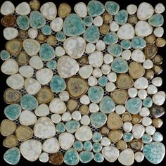 a close up view of some rocks and stones on a black surface with white dots