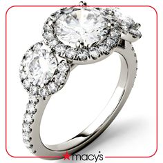 an engagement ring with three stone halos on the side and two round diamonds in the middle