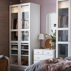 a bedroom with a bed, dresser and closet