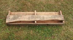 an old wooden box sitting in the grass