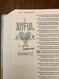 an open bible with the words joyful heart is good medicine