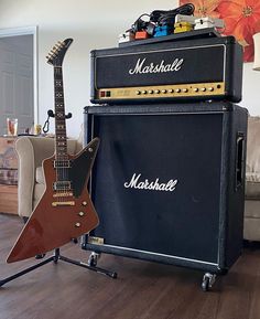 a guitar and amp sitting on top of a hard wood floor