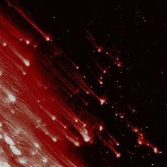 red and black background with white dots in the center, on top of dark ground