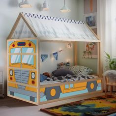 a child's bed with a yellow school bus tent on the top and bottom