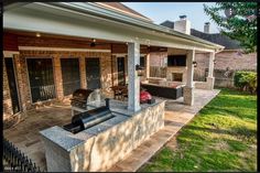 an outdoor patio with grill and seating area