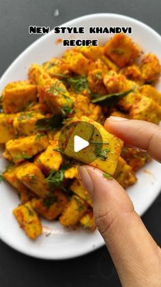 a person is holding up a piece of food on a plate with the words new style khadi recipe