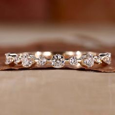 a diamond ring sitting on top of a piece of wood