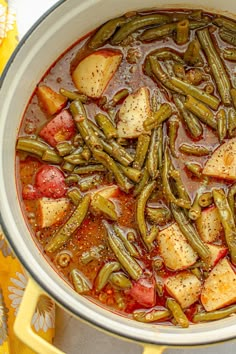 a pot filled with green beans and potatoes