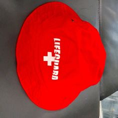 Lifeguard Hat. Has Bright Red Color. Lifeguard Logo In Front. Great Coverage For Sun Protection. New Without Tags Red Beach Cap, Red Cap For Vacation, Adjustable Red Bucket Hat, Casual Red Cap Sun Hat, Casual Red Bucket Hat For Beach, Casual Red Bucket Hat For The Beach, Red Outdoor Bucket Hat With Short Brim, Red Adjustable Bucket Sun Hat, Red Bucket Hat With Short Brim For Outdoor