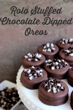 chocolate dipped oreos on a white cake plate