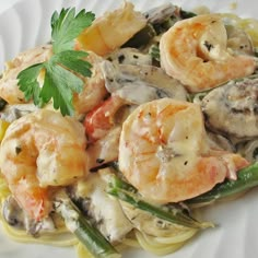 pasta with shrimp and asparagus on a white plate