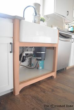 an open cabinet in the middle of a kitchen