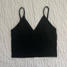 Nwot Never Worn Perfect And Super Cute Summer Crop V-Neckline, A Surplice Front, And A Cropped Fit 96% Cotton, 4% Elastane V-neck Tops With Built-in Bra, Black Stretch V-neck Crop Top, Black Seamless V-neck Top, Black V-neck Crop Top For Spring, Chic Black V-neck Crop Top, Chic Black Low-cut Top, V-neck Crop Top With Built-in Bra, Black V-neck Tank Top For Spring, Spring Black Low-cut Crop Top