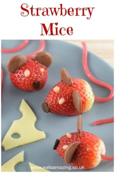 some strawberries are shaped like mice on a blue plate with the words strawberry mice