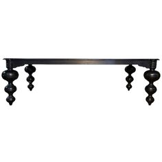 an iron shelf with three balls hanging from it's sides and four legs on each end