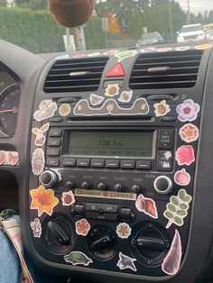 the dashboard of a car with stickers on it's dash board and steering wheel