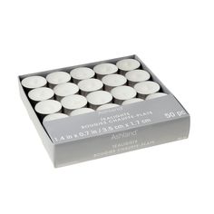 white candles in a box on a white background