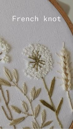 a close up of a cross stitch pattern with flowers and leaves on it that says french knot