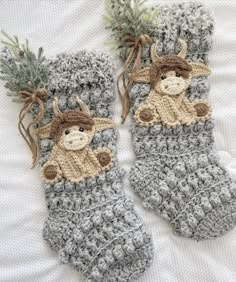 two crocheted socks with teddy bears on them, one is gray and the other is brown