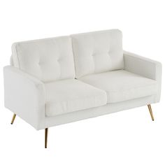 a white couch sitting on top of a wooden table