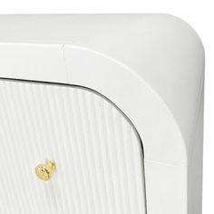 a close up of a white cabinet with gold knobs