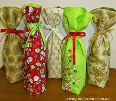 four different types of wine bags lined up on top of a wooden table next to each other