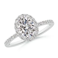 a white gold engagement ring with an oval cut diamond surrounded by pave diamonds