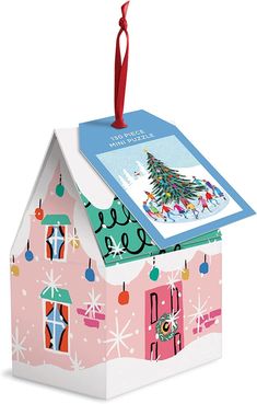 a pink house with a christmas tree on top