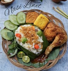 a basket filled with rice, cucumbers and other food on top of a table