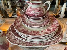 a stack of red and white china plates