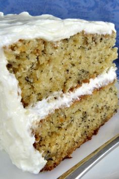 a piece of cake with white frosting on a plate